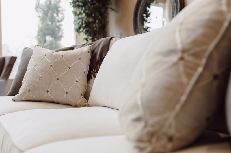 Couch with neutral-toned cushions