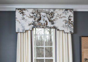 White curtains with art hanging over window