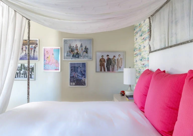 Teen's bedroom with pink accents and band posters