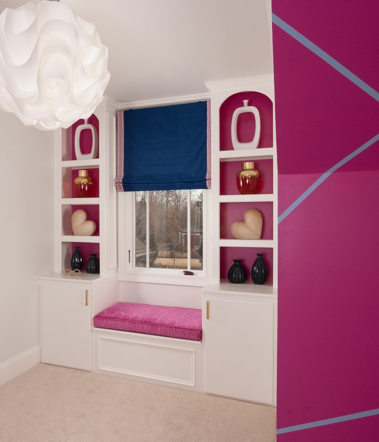 Room with built-in shelves with pink painted accents
