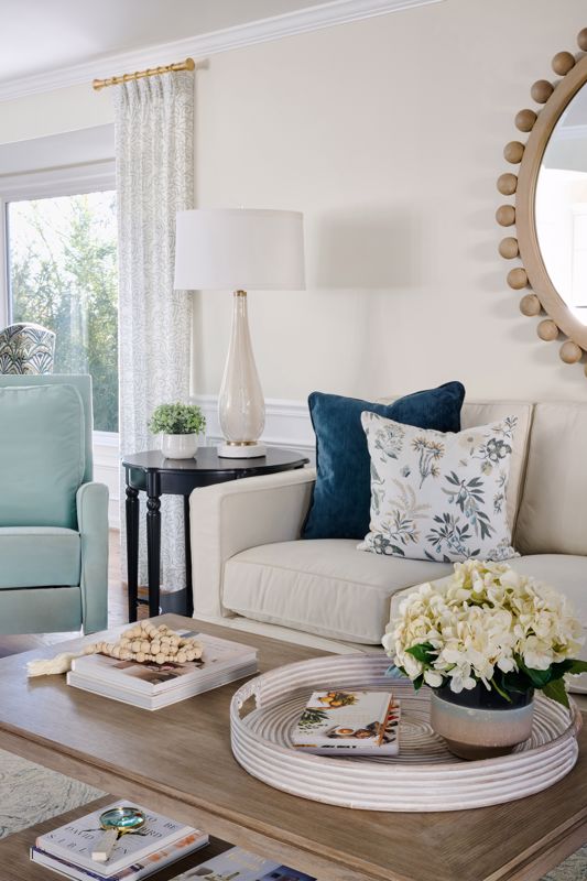 muted browns and cream colored furniture with blue accents showcasing the coastal grandma interior design style in summer