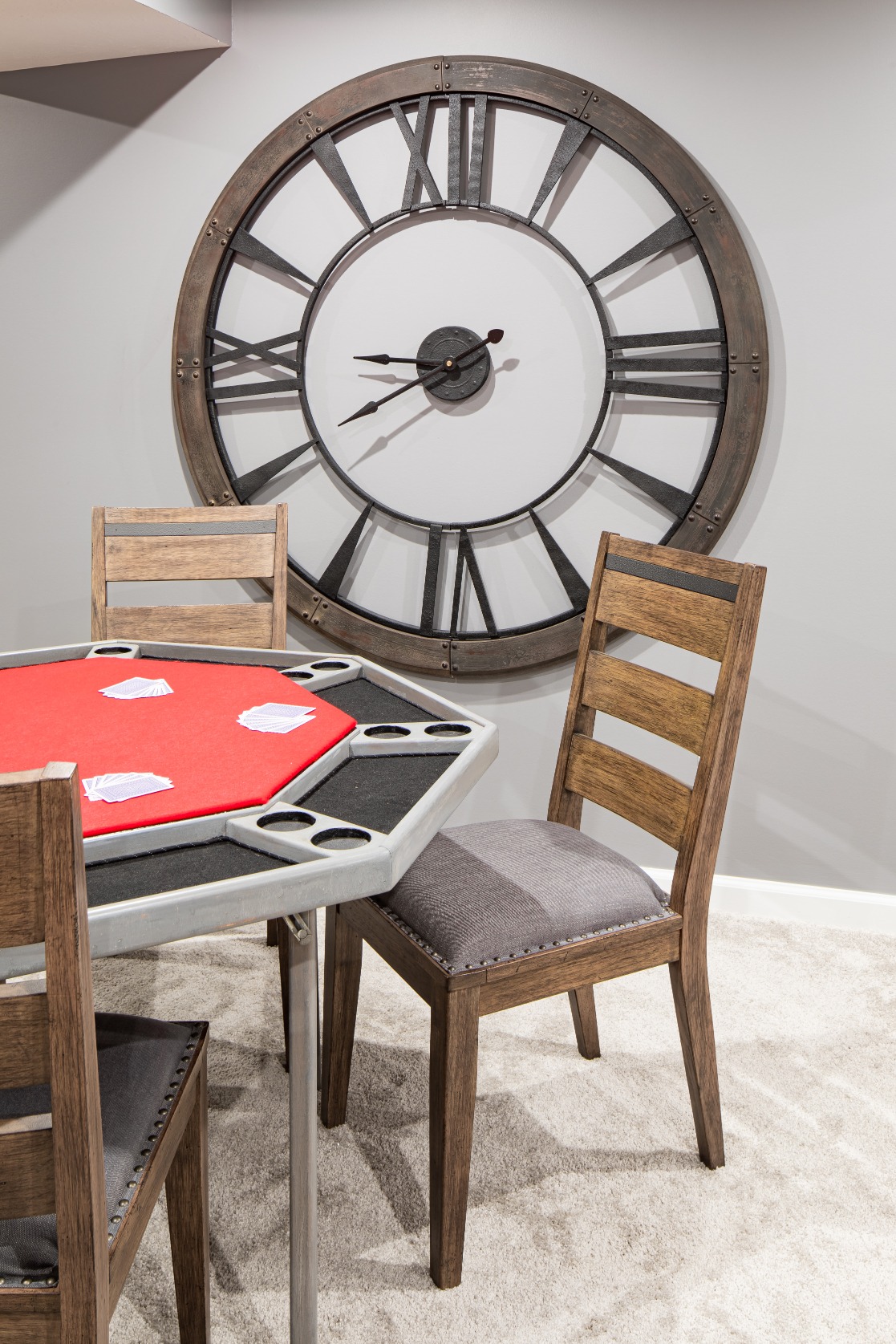 Poker table with chairs and a large wall clock
