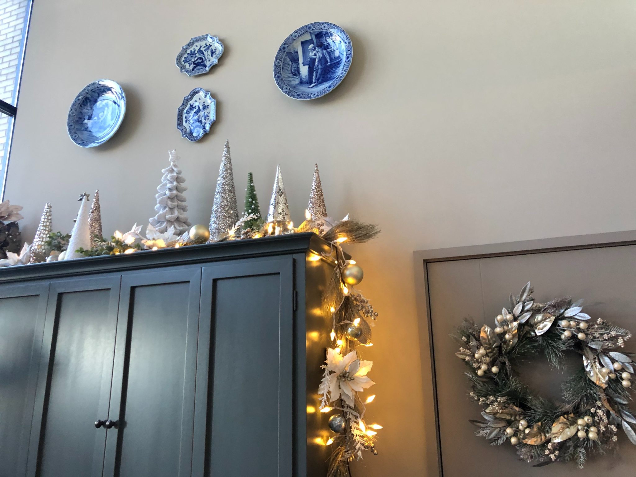 Christmas lights and decor on a dark cabinet
