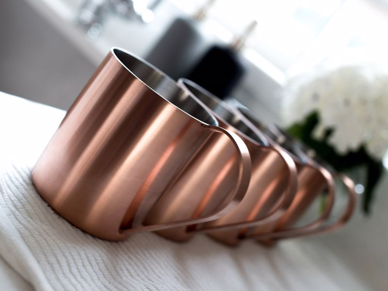 Lined up copper mugs