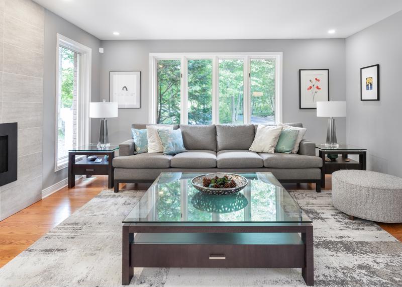 Glass-topped coffee table with grey furnishings