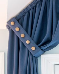 Curtains buttoned to create a foldover effect