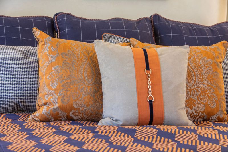 Orange and Blue bedcover with decorative pillows