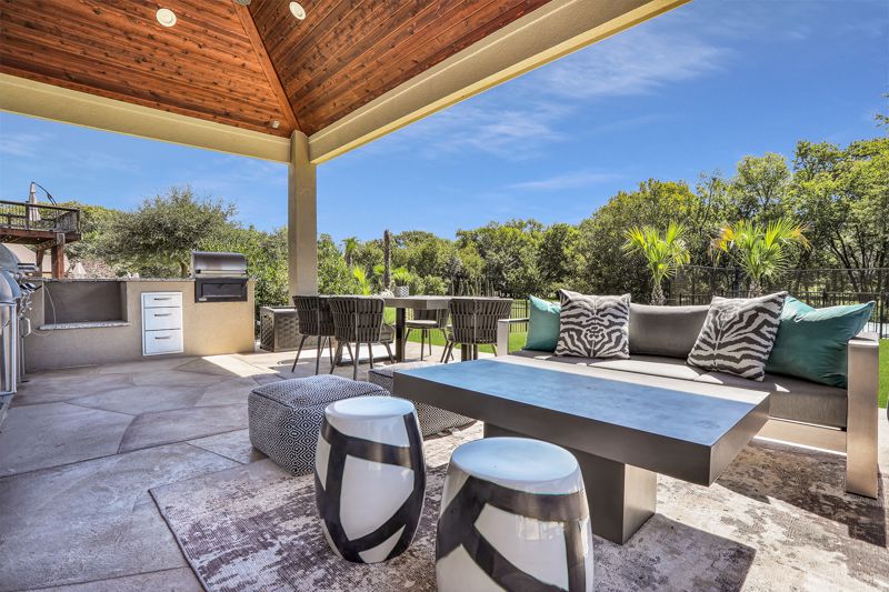 Outdoor entertainment space with seats and kitchen