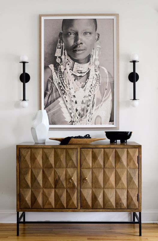 Framed photo of a woman over a cabinet 