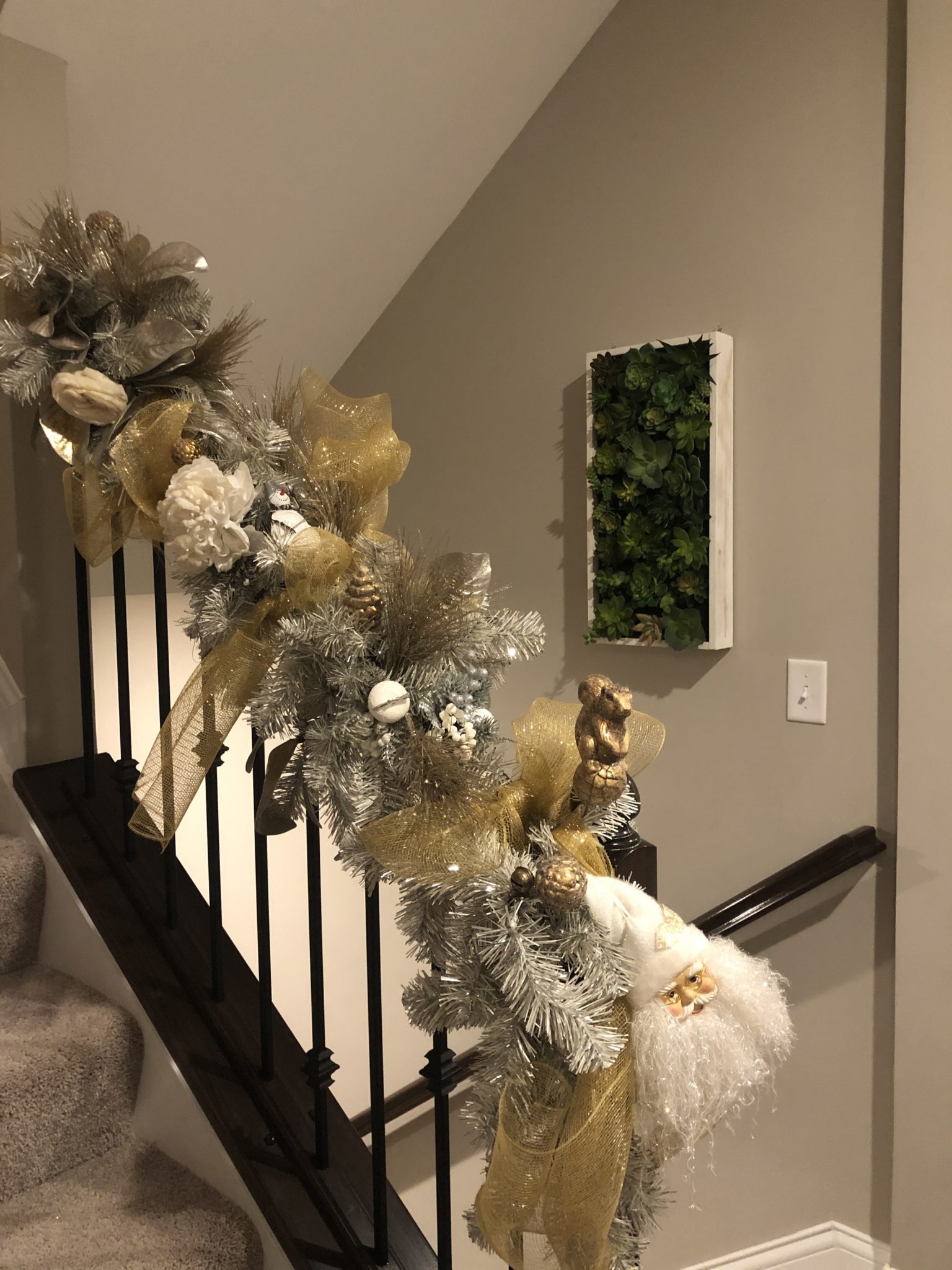 Staircase with railing wrapped in festive garland