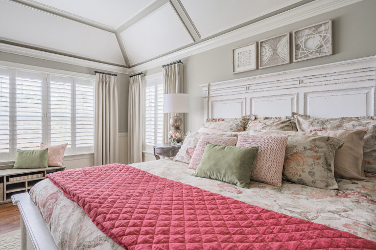 Classically-styled bed with pink runner