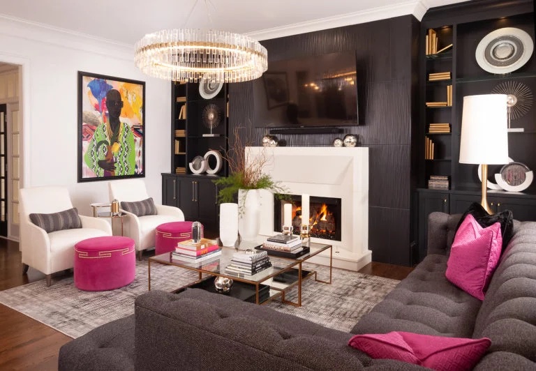 Living room with white and black furniture and pink pillows