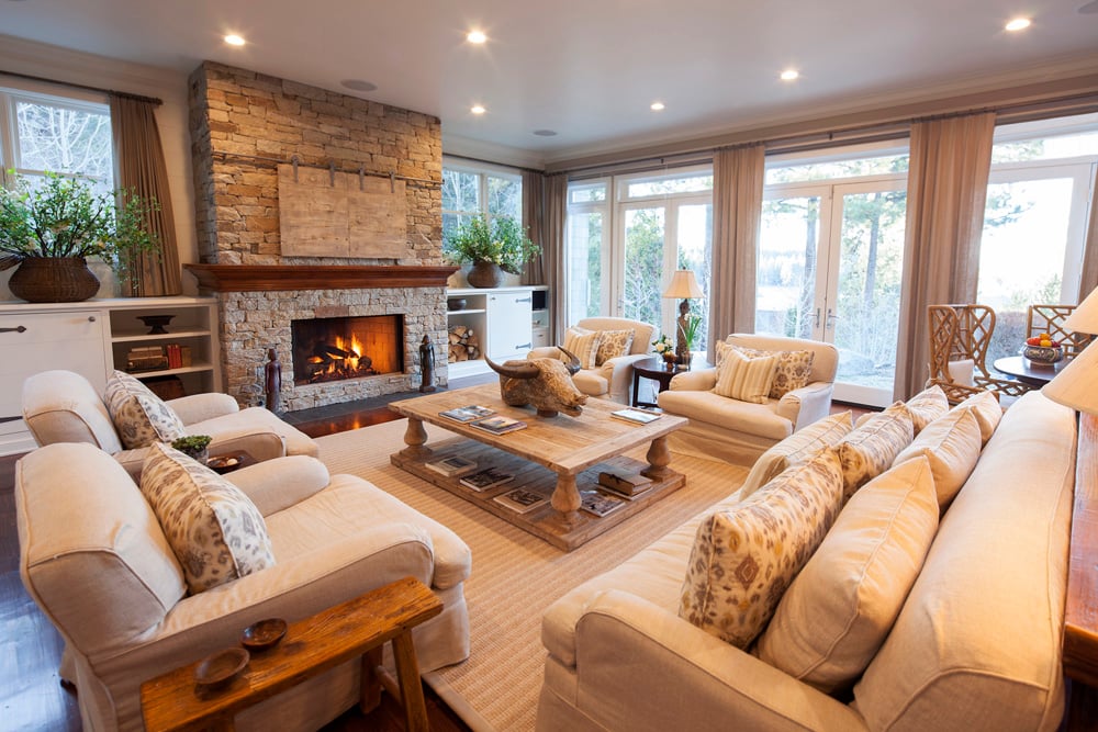 rustic styled living room with a stone fireplace