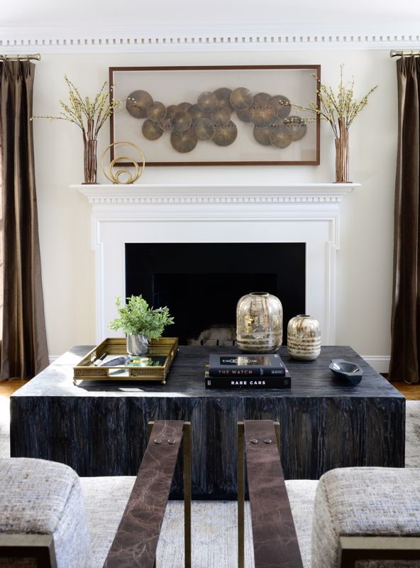 decor hung around a coffee table and fireplace