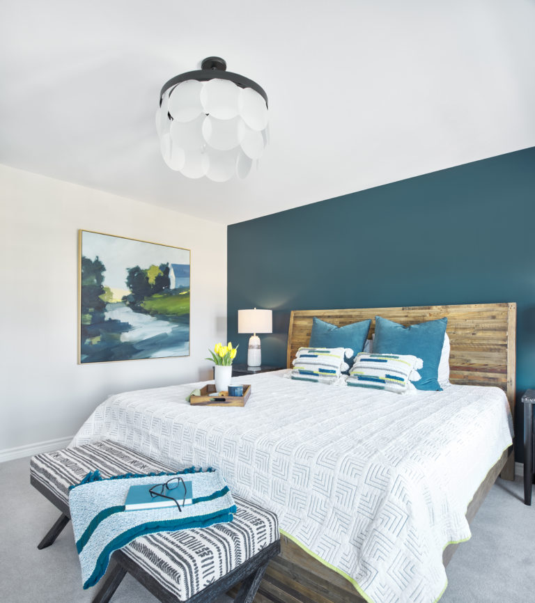 clean bedroom with white and teal decor