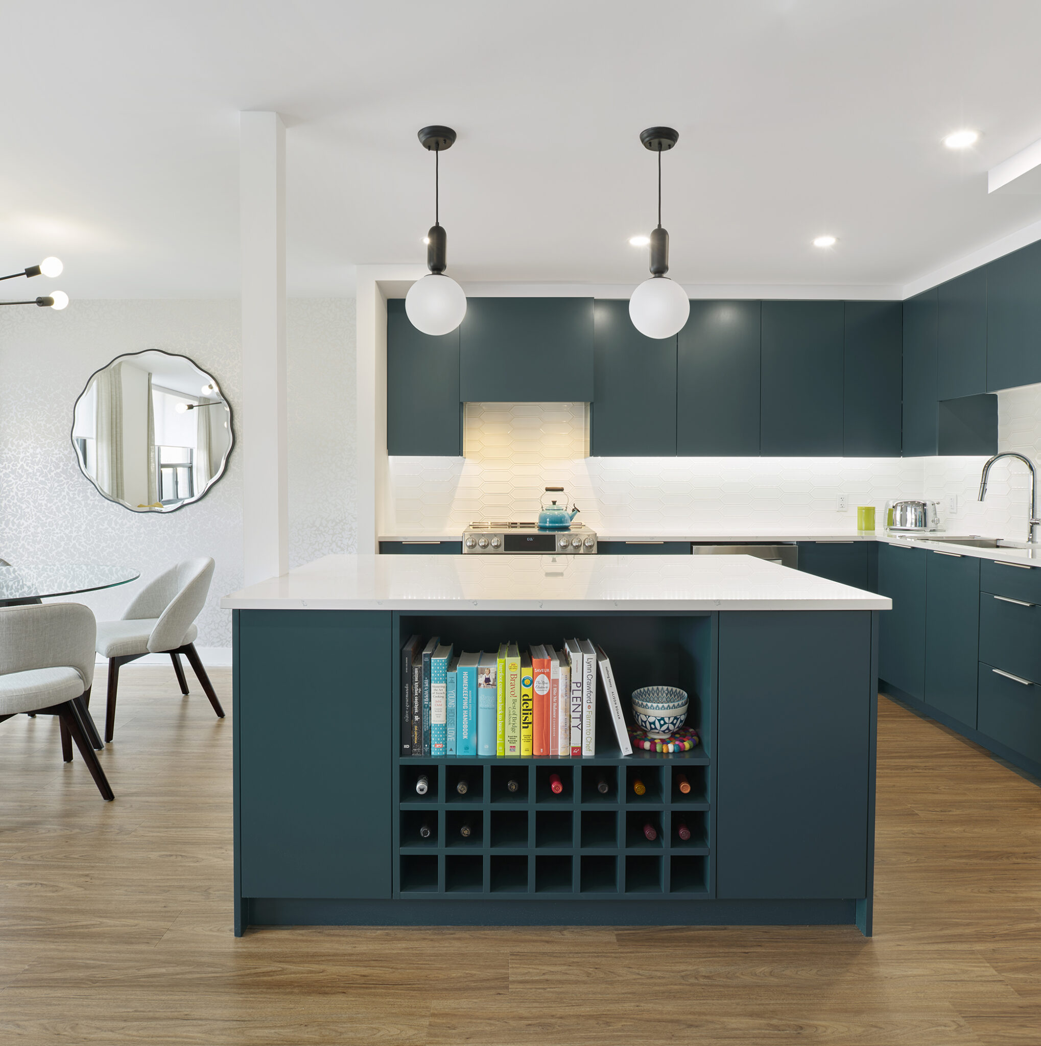 Minimalist kitchen with blue-green island and cabinets