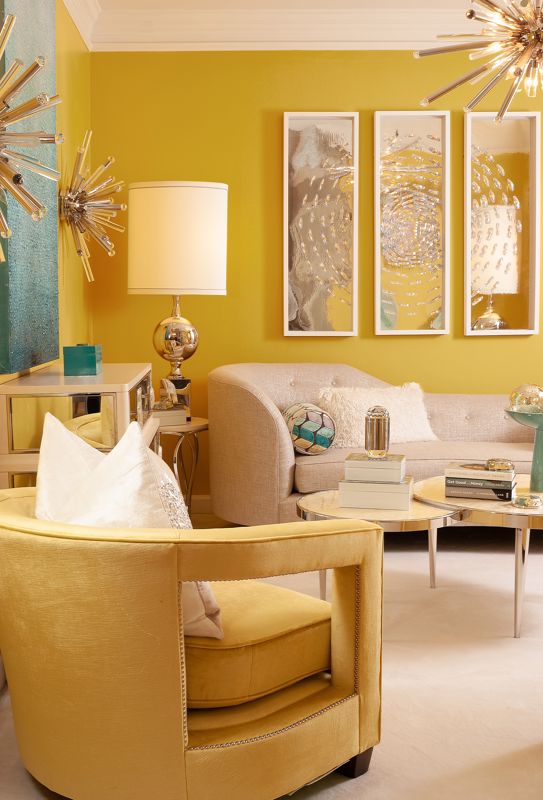 yellow chair with white pillow set against beige couch and bright yellow walls interior design