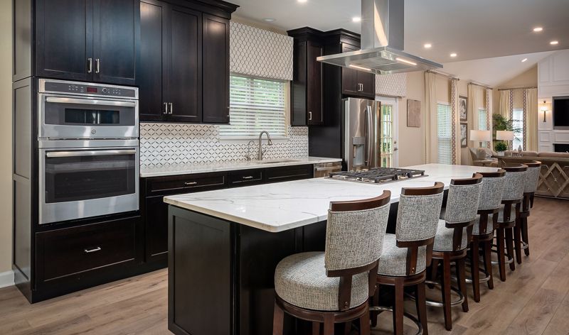 white chairs in front of white countertop in a cincinnati kitchen with dark cabinets