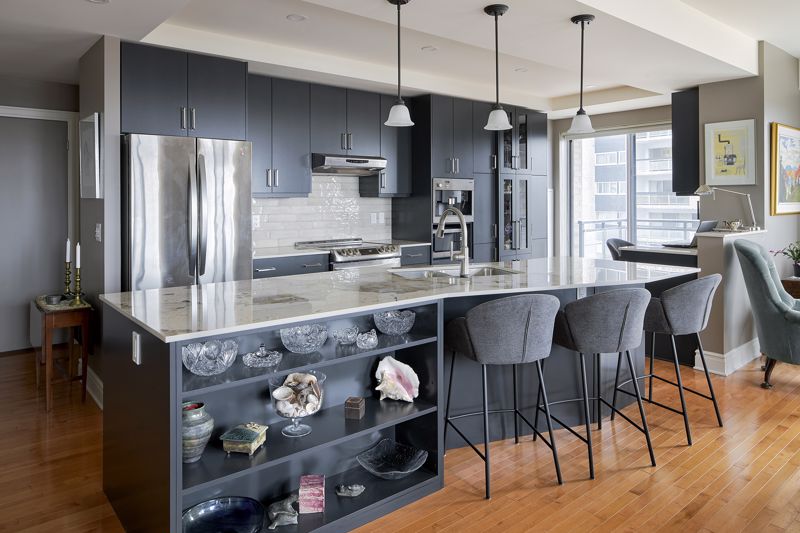 charcoal black chairs and shelving for decorations at breakfast nook and kitchen island on hardwood floors in Cincinnati home