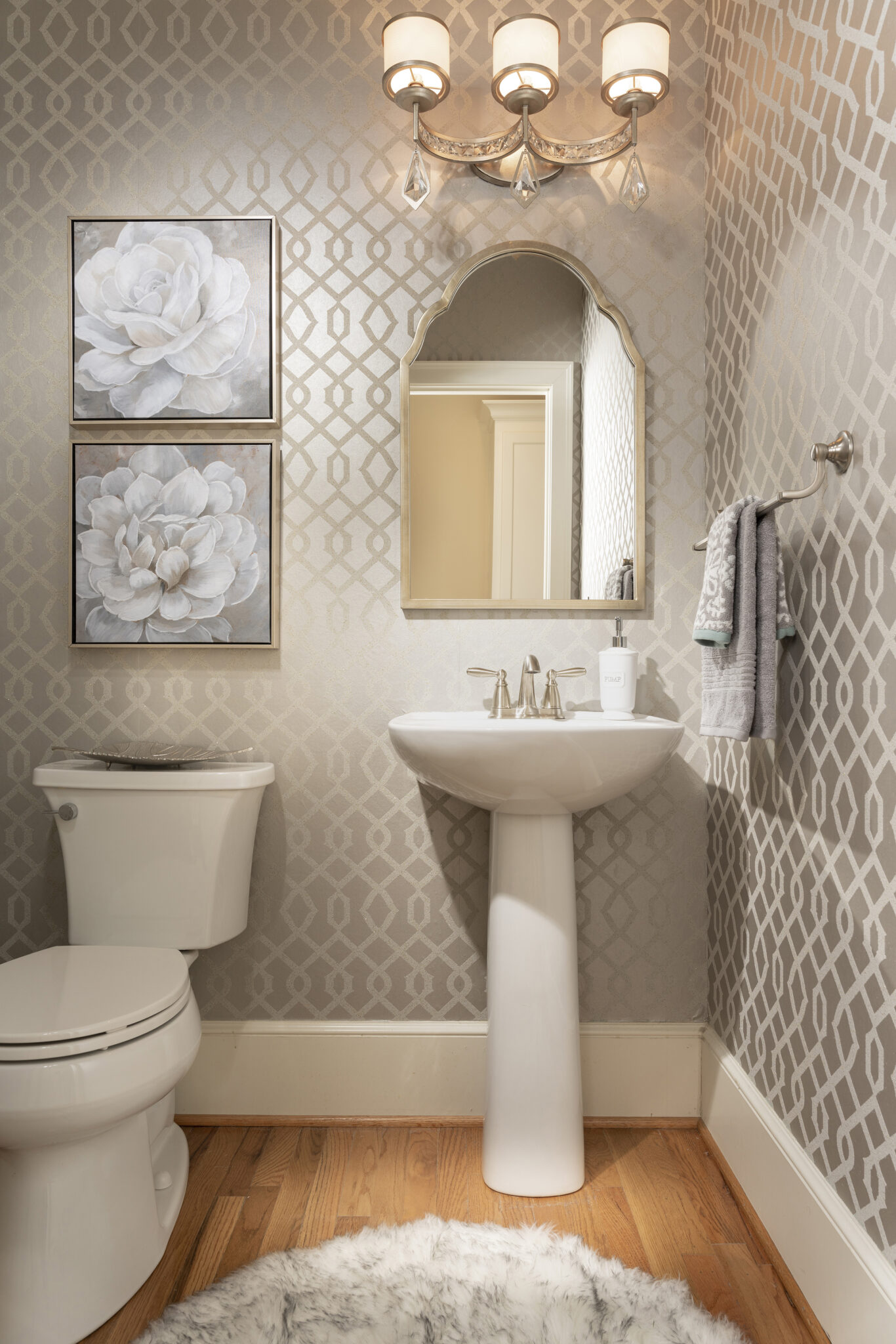 small guest bathroom with large geometric pattern wallpaper showcasing bathroom interior design in cincinnati
