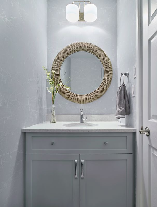 metal circular mirror and gray vanity for bathroom interior design
