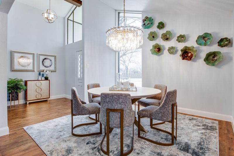 gray print antique chairs and vintage chandelier in modern dining room showcasing modern vintage design style in Cincinnati OH